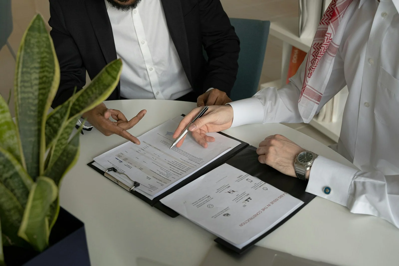 Reviewing a contractor agreement together at a desk